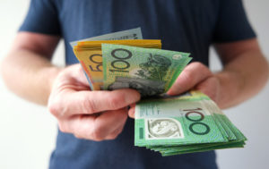 Male holding Australian Cash Currency